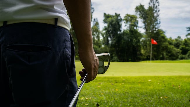 Man approaching putting green