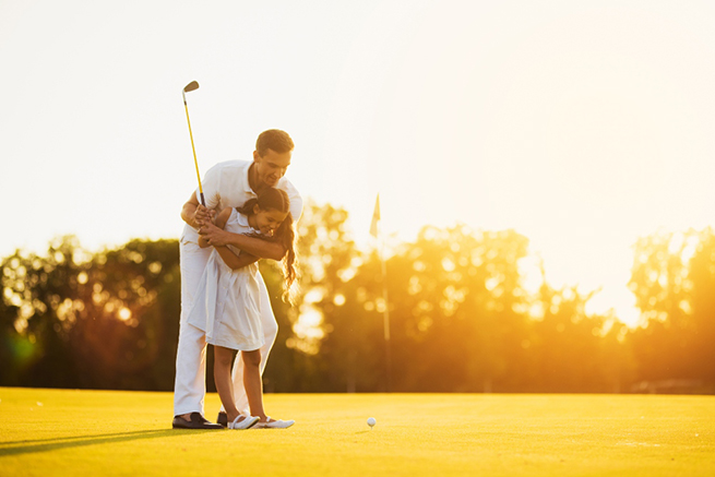 man golfing with a child